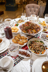 Top view of set table with Kuirdak bread rolls and fruits in restaurant