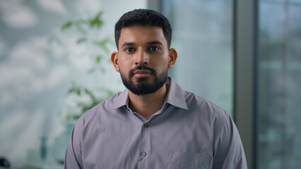 Portrait in office Arabian ethnic Muslim business man posing in workplace serious calm businessman...