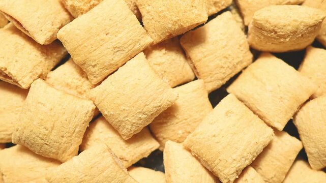 Corn puffs. Breakfast cereal texture. food background