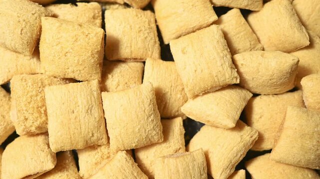 Corn puffs. Breakfast cereal texture. food background