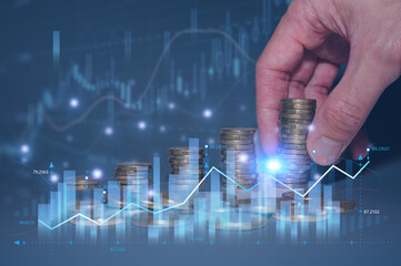 Businessman stacking coins with a rising graph, a rising stack of coins symbolizing savings and financial growth