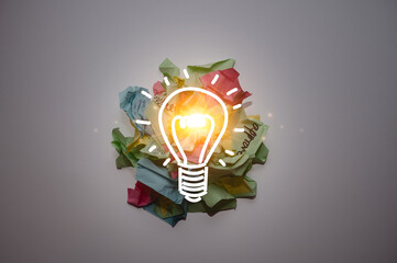 Glowing light bulb icon emerging from crumpled colorful paper notes symbolizing creativity, idea generation, innovation, brainstorming, problem solving, inspiration, and creative thinking.
