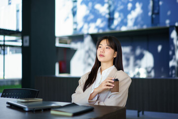 young woman enjoying morning coffee hot drink and smiling outdoors. Relaxing, taking a break. Lady girl walking on urban city street drinking coffee to go. Town lifestyles. Sunny park