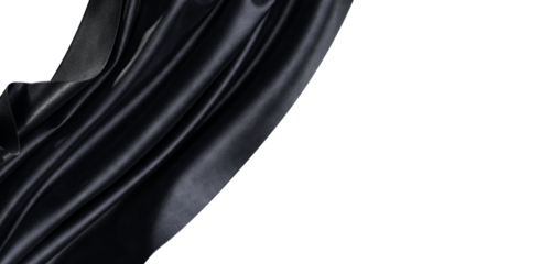 Dramatic view of a luxurious black fabric with beautiful folds and texture. The light catches the material creating a se