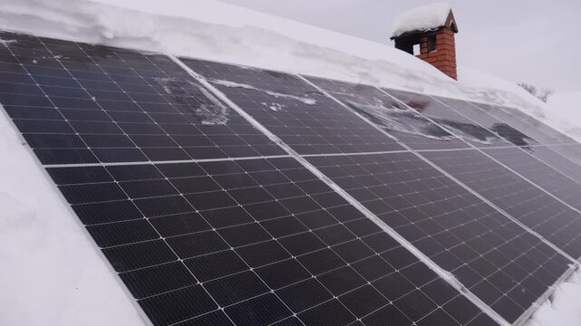 solar panels are cleared of snow in winter