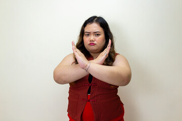 Woman making X gesture, stop sign, saying no, disapproval, negative emotion, overweight female