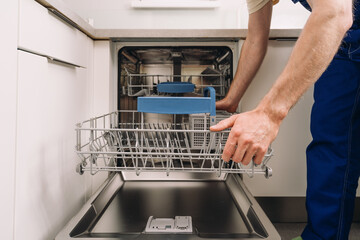 Home maintenance service for broken dishwasher in modern kitchen setting