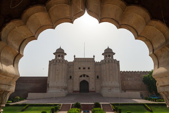 View of sunlight bathing the imposing Lahore Fort gate, framed by an ornate archway, creating a sense of grandeur and timeless beauty, Lahore, Punjab, Pakistan.
