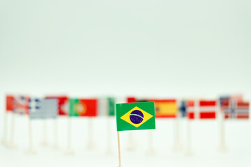 Small flag of Brazil stands out among many flags on display at an event representing different countries