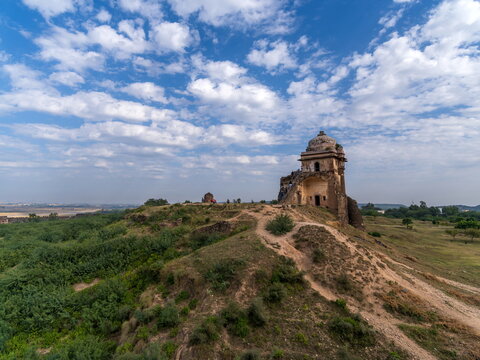 View of the ancient fort ruins standing majestically against the blue sky dotted with fluffy white clouds, Rohtas Fort, Punjab, Pakistan.