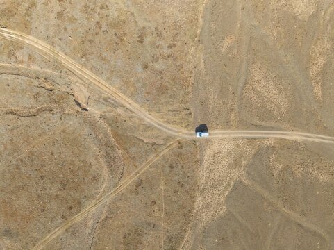 Aerial view, Vast empty landscape, Road and off-road vehicle, Top down view, Two paths divide, Symbolic for decisions, Moldo Too mountains, Naryn region, Kyrgyzstan