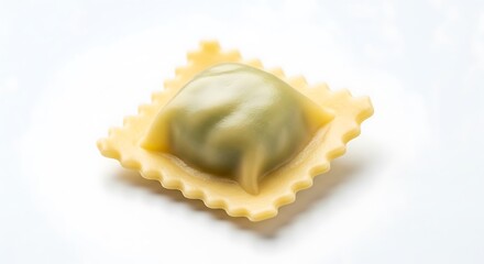Single Uncooked Ravioli with Green Filling on White Background