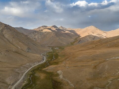 Aerial view of mountain valley with gravel road, Naryn region, Kyrgyzstan