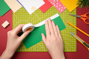 Making a gnome craft. The hands are attached to a piece of paper with double-sided tape. The creative process.