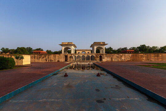 View of the serene Hauz-i-Khas pool reflecting the historic structure, a tranquil scene bathed in the soft glow of dawn, Lahore, Punjab, Pakistan.