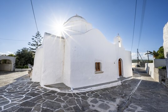 White Greek Orthodox Church of Agios Modestos with Star of the Sun, alleys of the village of Marpissa, Paros, Cyclades, Greece