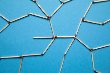 Global network connection made by match on the blue background.