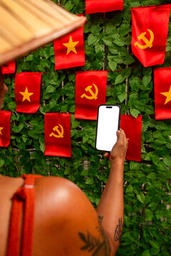Tourist holding phone showing blank screen in Hanoi