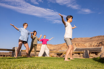 Friends enjoying morning exercises in African landscape