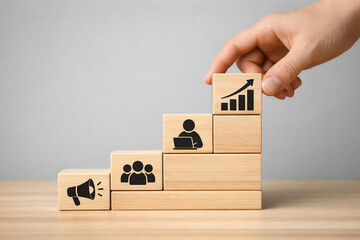 Strategic Business Expansion and Leadership Concept Represented by Stacked Wooden Blocks with Marketing and Growth Icons