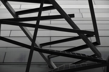 Black metal staircase against a brick wall background