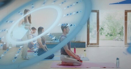 Leading instructor in light pants guiding three kneeling students on mats in bright studio, overlay