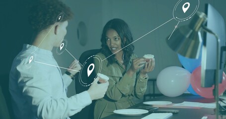 Sharing coworkers wearing business-casual clothes, holding cupcakes at desk with balloons, AR pins