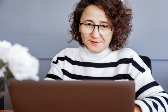 Woman in office using laptop for work