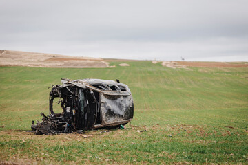 Wrecked car overturned after roadside accident