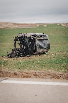 Overturned vehicle and roadside crash scene
