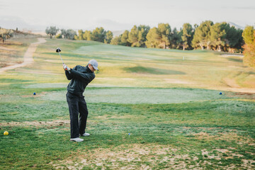 Golfer enjoying weekend recreational sport outdoors