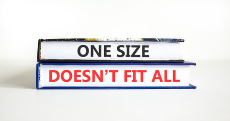 Fototapeta premium One size does not fit all symbol. Concept words One size does not fit all on beautiful books. Beautiful white paper background. Business one size does not fit all concept. Copy space.