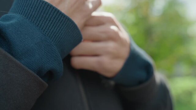 Secure outdoor zipper, Preparing for morning run with sharp detail, Closeup of hoodie being fastened for outdoor jog, Athlete securing hoodie zipper tightly before heading out for morning exercise