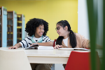Student and library with books. Students read books in library room at school. Students of diverse nationalities in library. Learning or university education