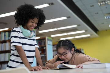 Student and library with books. Students read books in library room at school. Students of diverse nationalities in library. Learning or university education