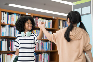 Student and library with books. Happy smiling women students with books in library room at school. Students of diverse nationalities in library. Learning or university education