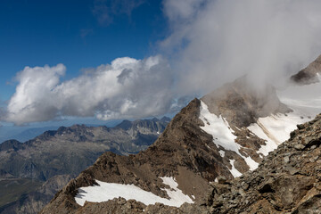 Panoramic alpine viewpoint from Pic Blanc at 3300 meters near Alpe d&rsquo;Huez in the Grandes Rousses massif, French Alps