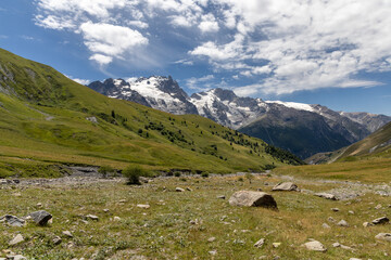 Mountain landscape in the Arves Massif, French Alps, with the iconic La Meije peak in the...