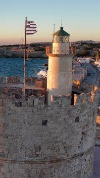 Aerial view of saint nicholas fortress lighthouse in rhodes greece during golden hour