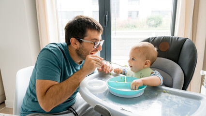 Father and baby during a weaning meal together