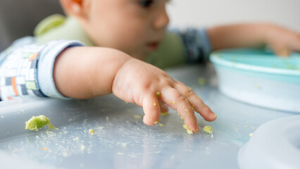 Baby exploring food with baby led weaning approach