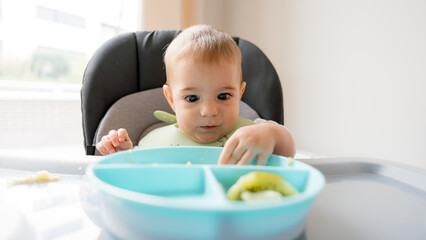 Baby explores food during baby led weaning session