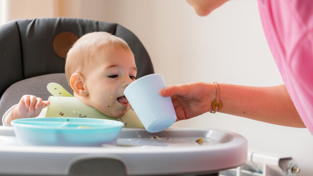 Baby led weaning with family in kitchen setting