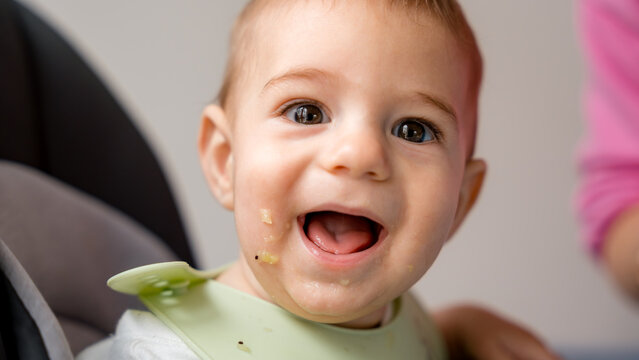 Baby enjoying first bites with baby led weaning approach