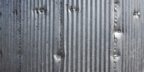 Galvanized corrugated metal background used in agriculture buildings offering security for stored food supplies. durable rustic pattern creates an industrial texture