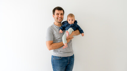 Father holding baby in arms with affectionate smile