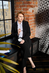 Redheaded professional analyzing ideas in modern office environment