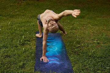 Person executing core stretch in nature with intense focus