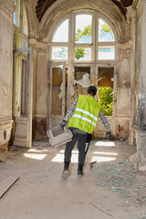 Reflective dressed worker moves through corridor during repair