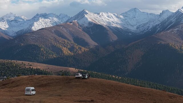 Aerial Panning Over Overlanding SUVs in Snowy Alpine Mountains